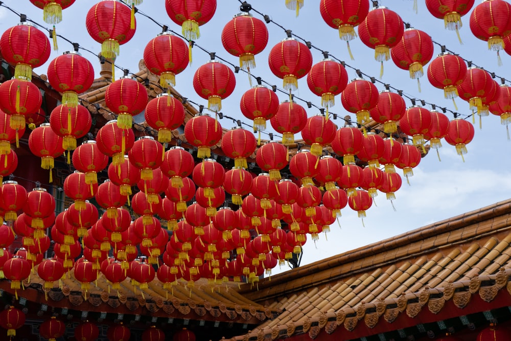 a bunch of red lanterns hanging from a wire