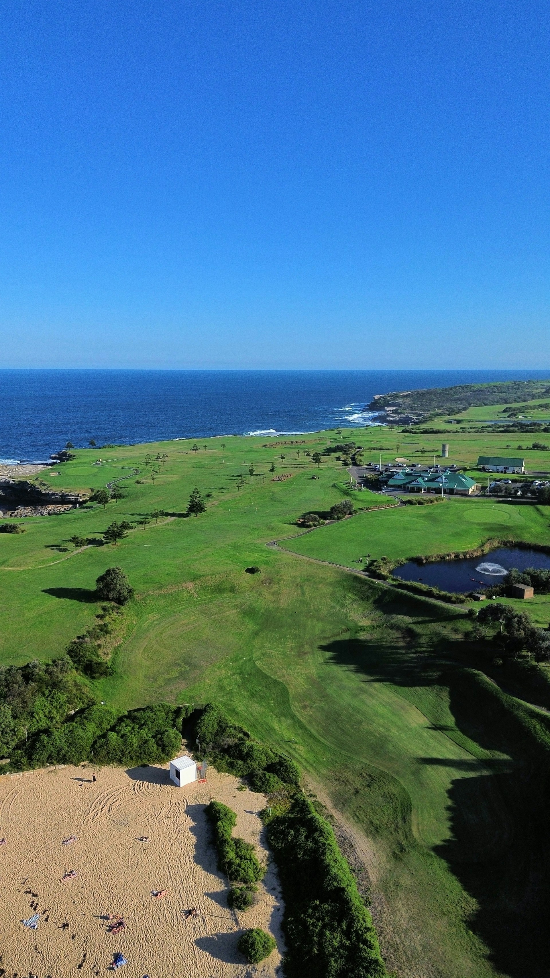 an aerial view of a golf course near the ocean