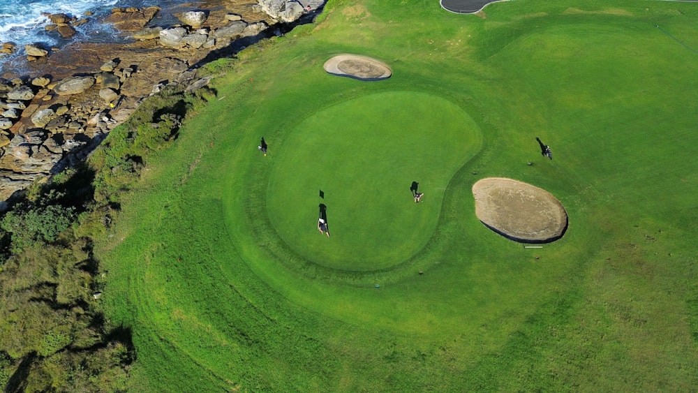 an aerial view of a golf course near the ocean