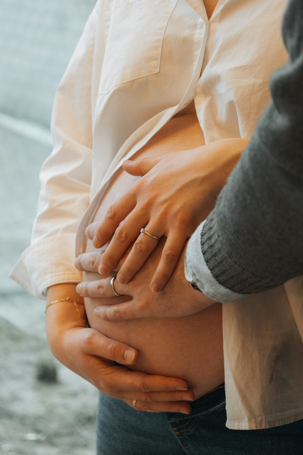 a person holding their stomach with both hands