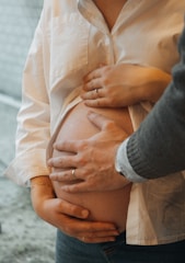 a pregnant woman is holding her belly in her hands