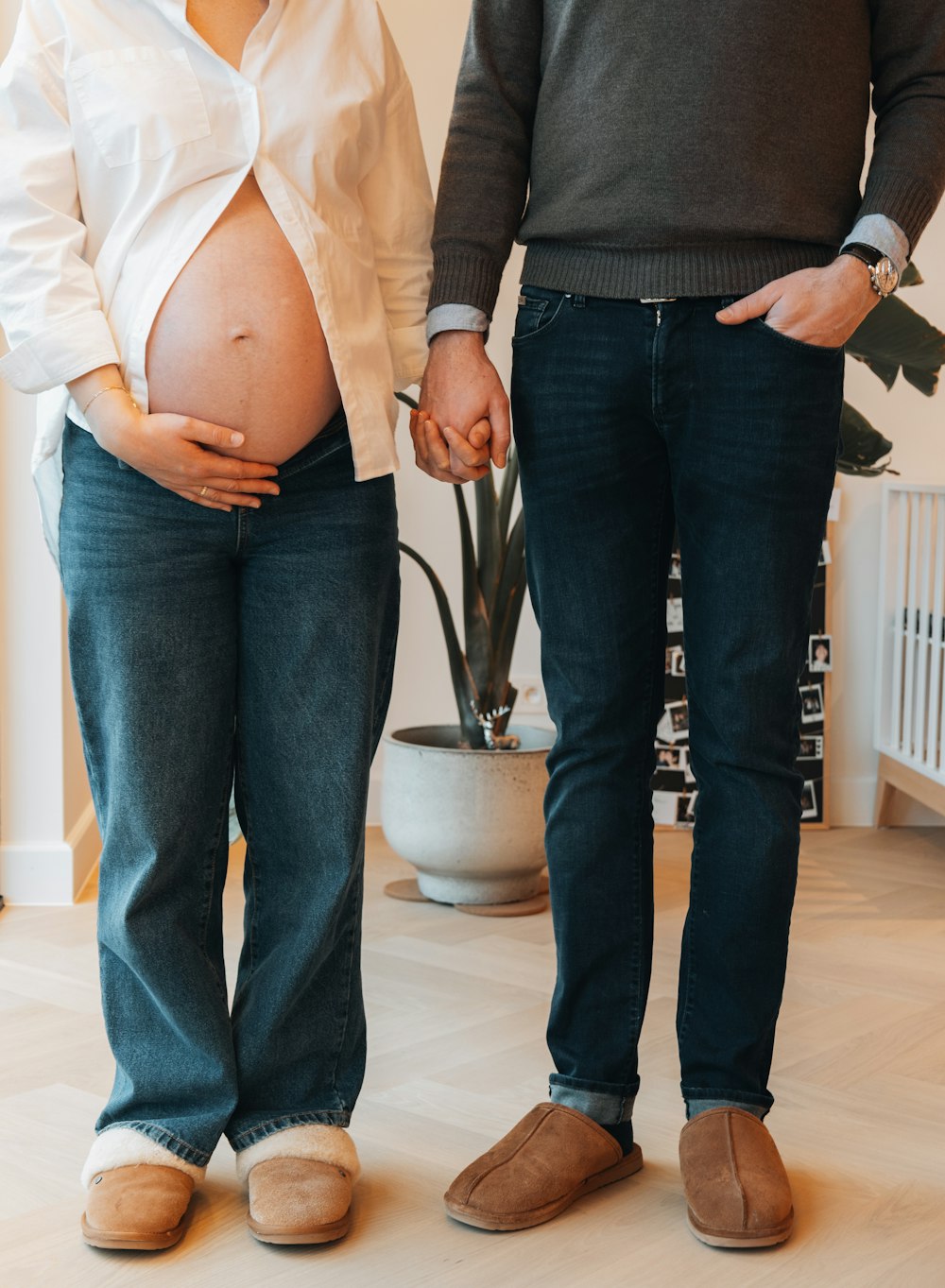 a pregnant woman standing next to a man