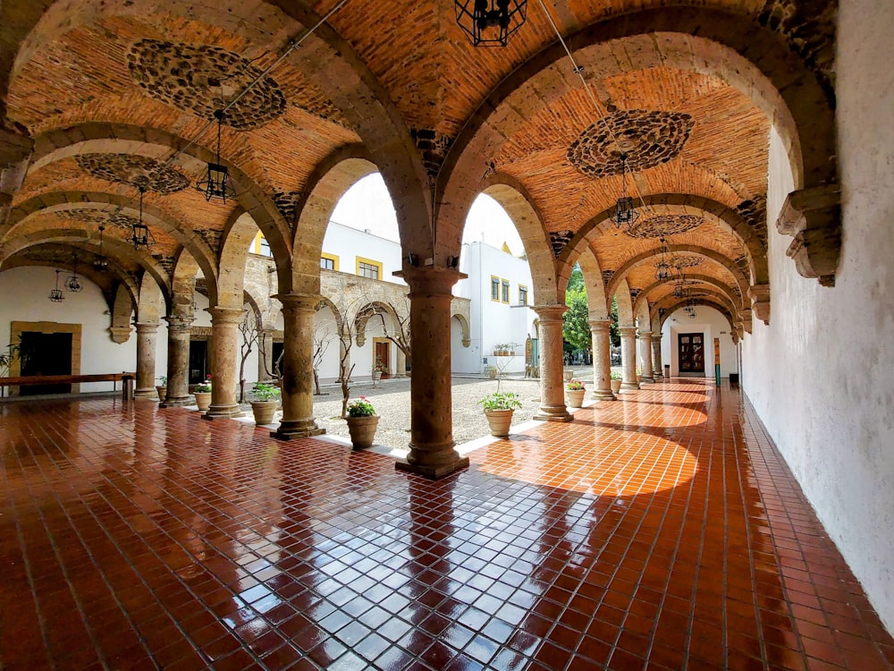 a long hallway with arches and a tiled floor
