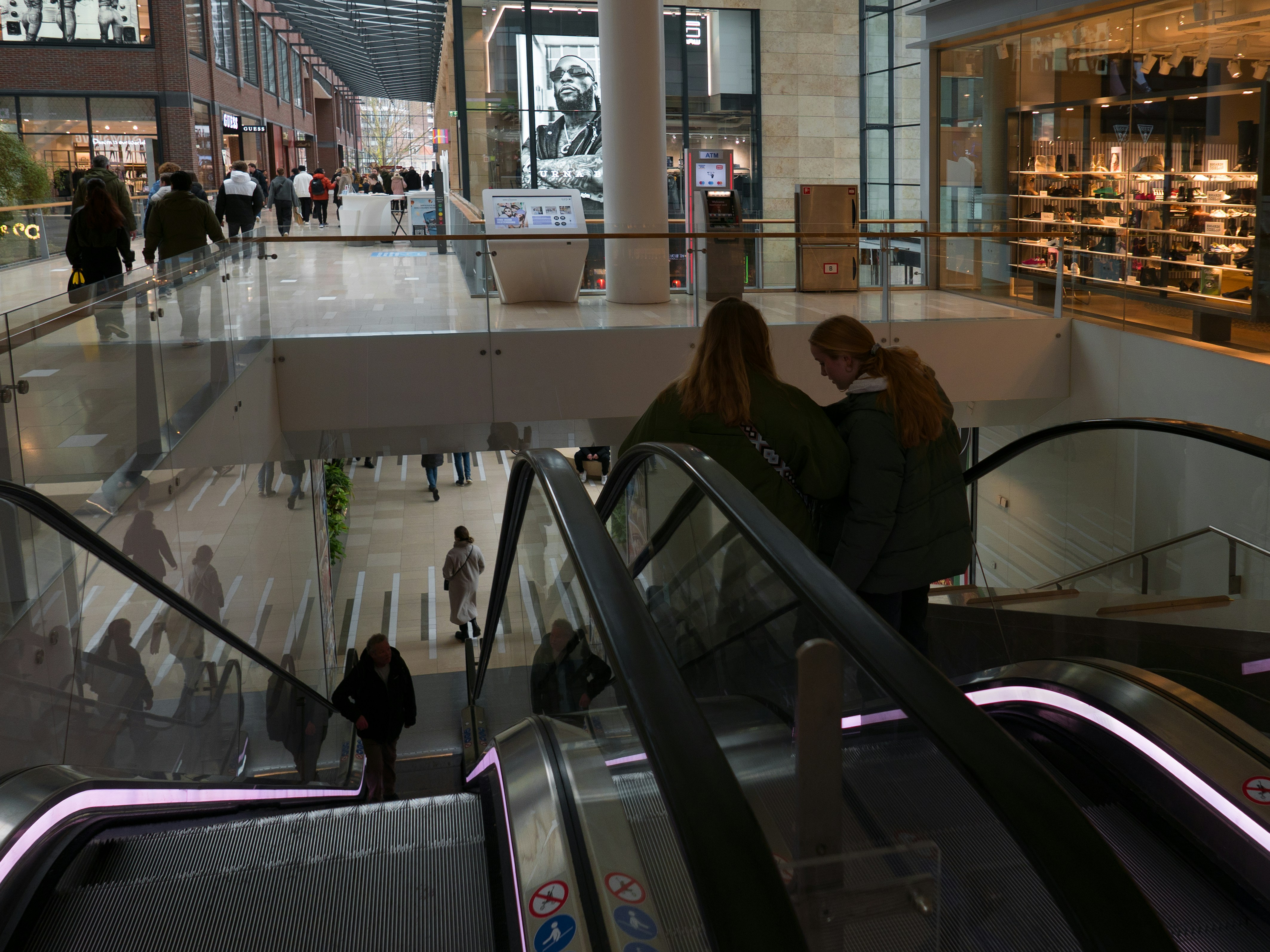 Young women on the escaloator in the modern shopping mall Hoog Catharijne, in Utrecht city - The Netherlands. This modern architecture had a clear interior light and a lot of transparency. . Street photography in Utrecht, The Netherlands by Fons Heijnsbroek; free download photo. This urban image is shared by me as free photo in suitable resolutions for making a good art print or wallpaper.