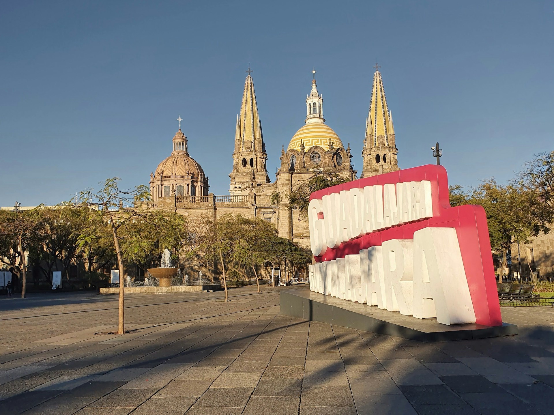 a large red and white sign sitting in front of a building