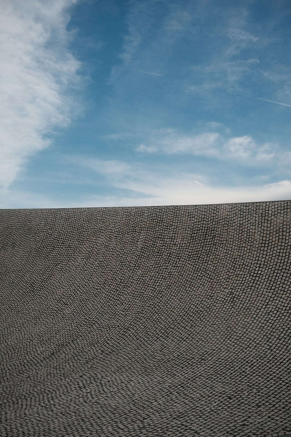 a person flying a kite on top of a hill