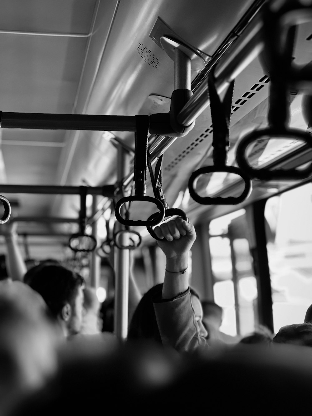 a black and white photo of people on a bus