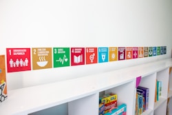 a row of colorful signs on a white shelf