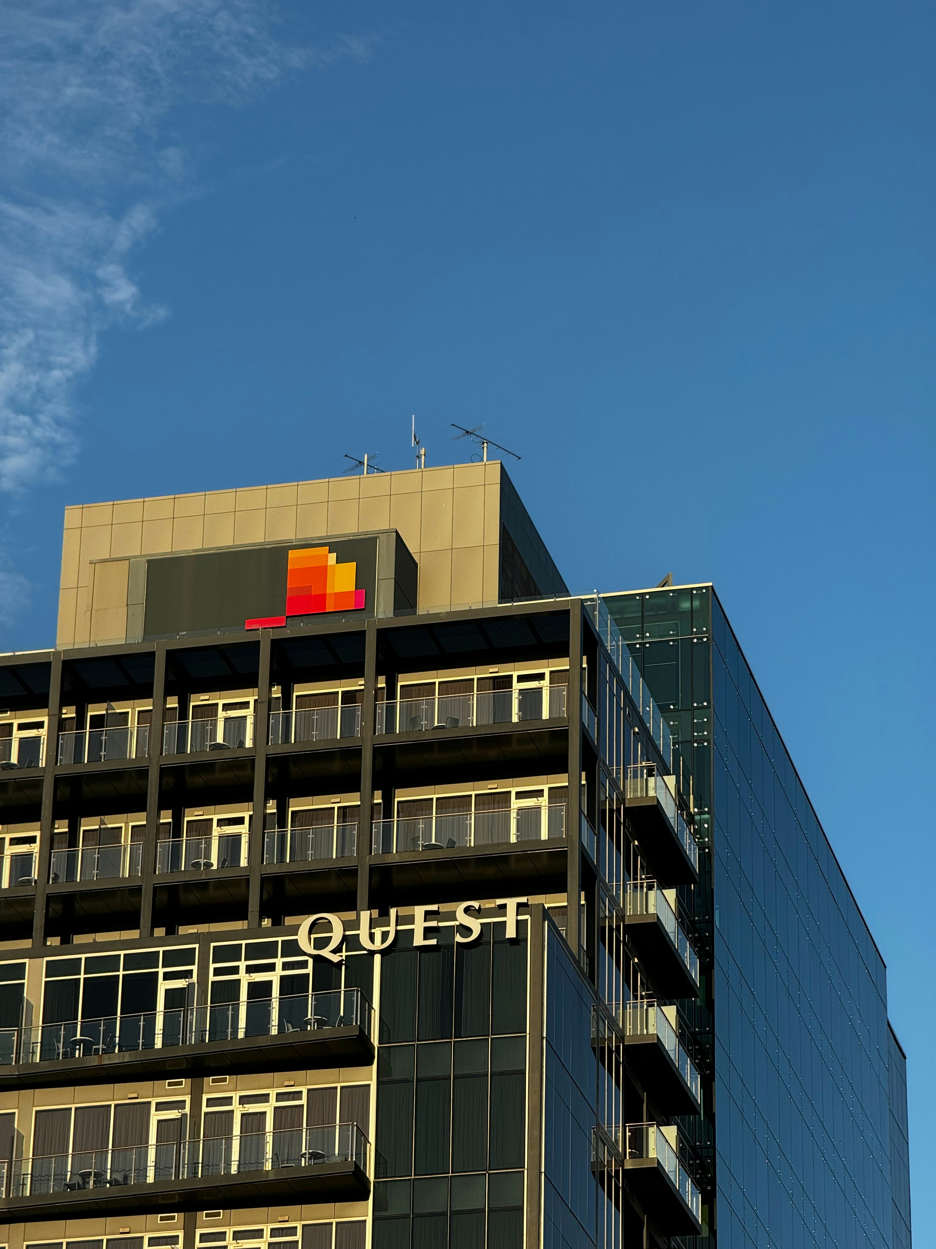 a tall building with balconies and balconies on top