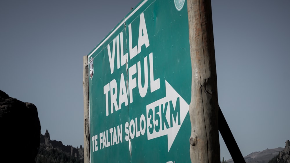 a green street sign with white arrows pointing in different directions