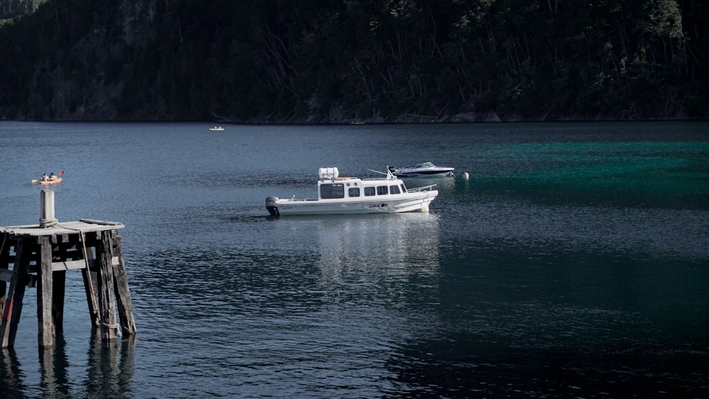 a boat is out on the water near a pier