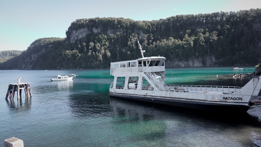 a large white boat floating on top of a lake