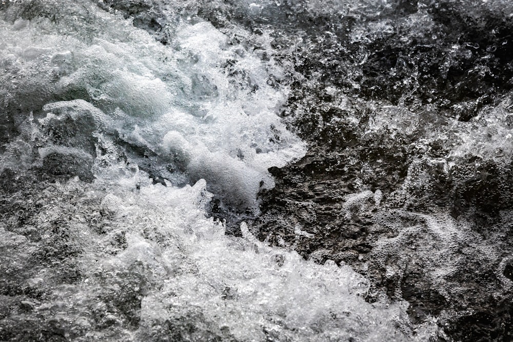 a black and white photo of water and rocks