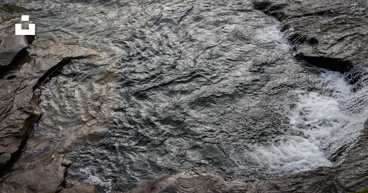 Stream Between Two Rocks A stream of water running between two rocks photo – Free Splash Image ...