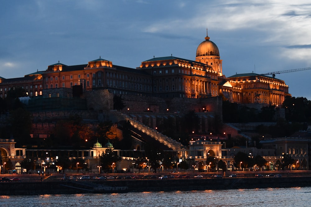 a castle lit up at night on top of a hill