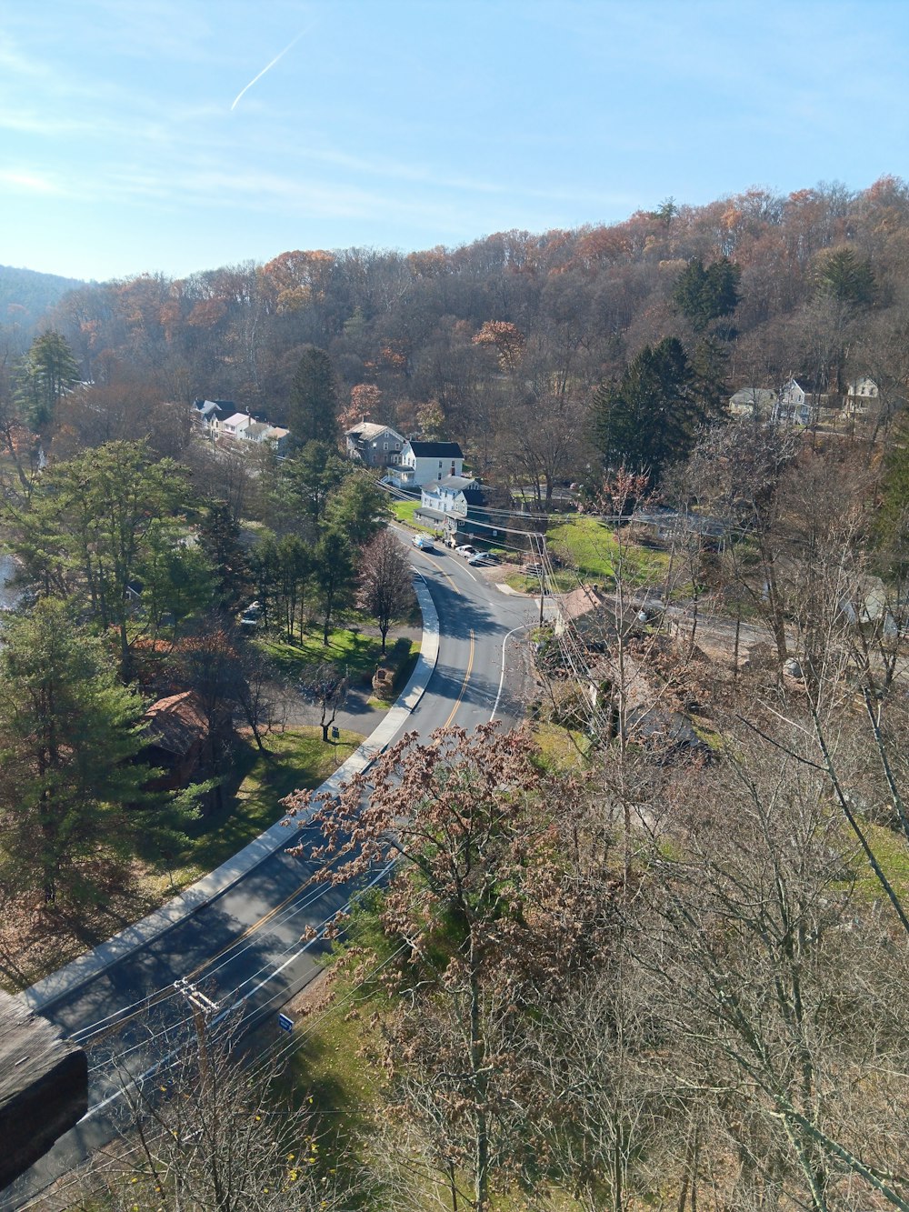 a view of a road in the middle of a wooded area