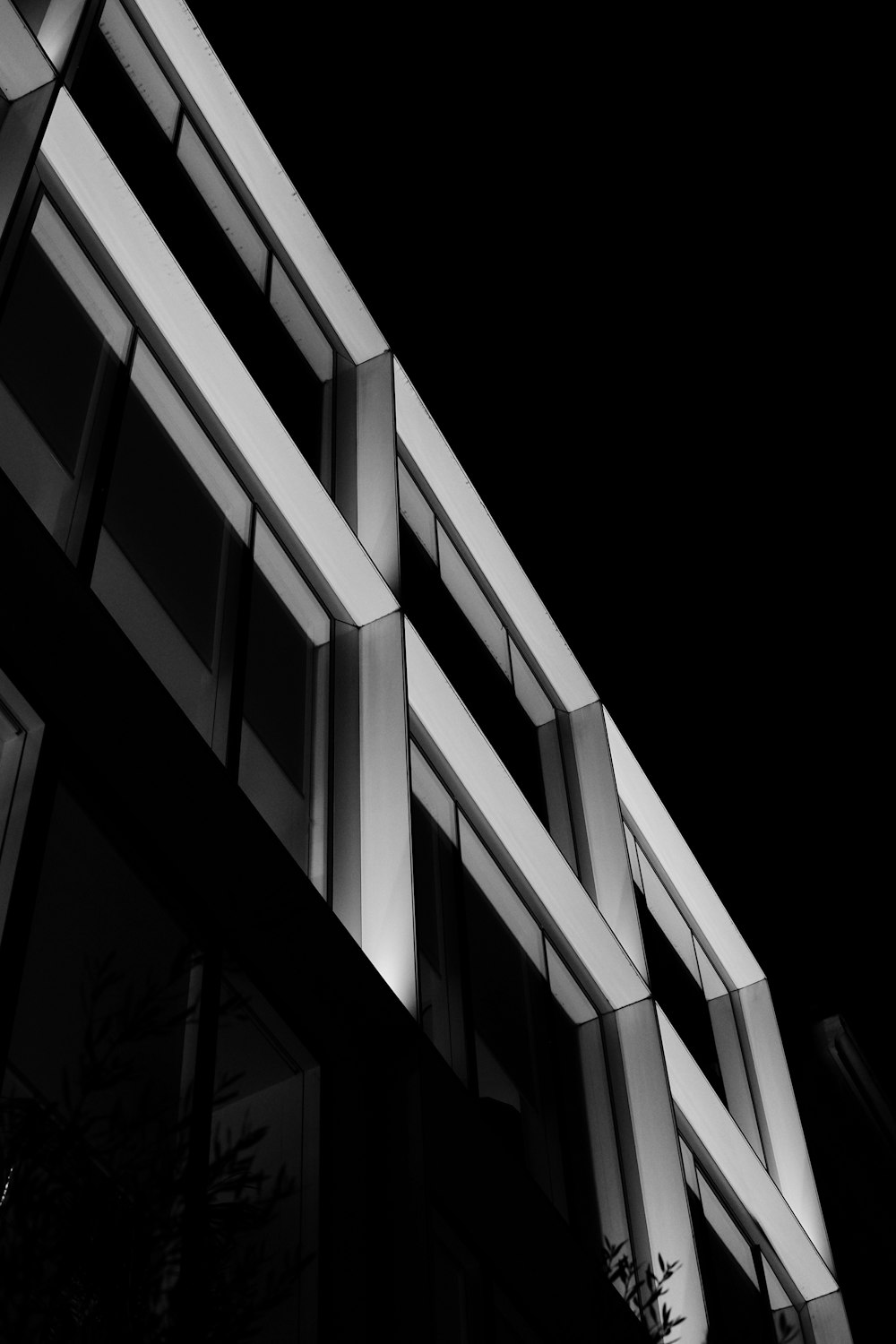 a black and white photo of a building at night