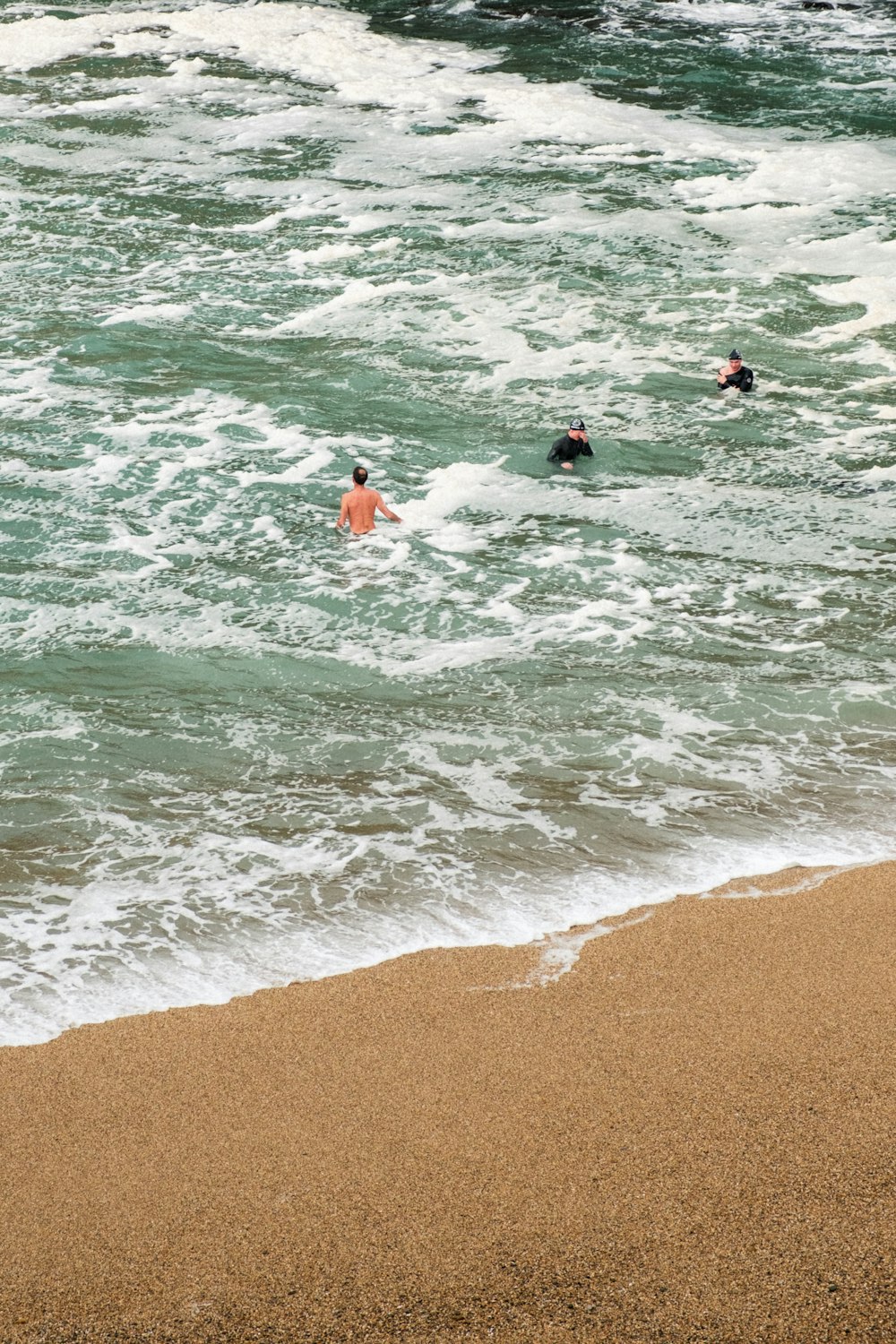 a group of people swimming in the ocean