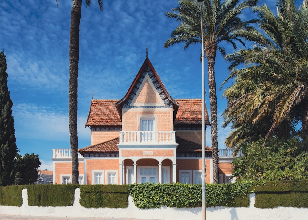 a large house with palm trees in front of it
