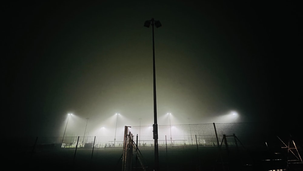 a foggy night at a soccer field with lights on