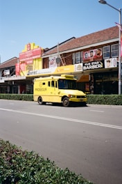 a yellow bus parked on the side of the road