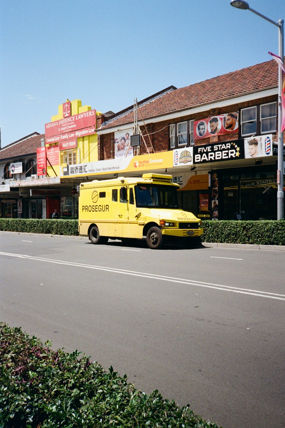 a yellow bus parked on the side of the road
