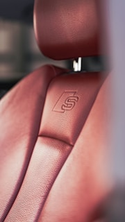 a close up of a red leather seat on a car