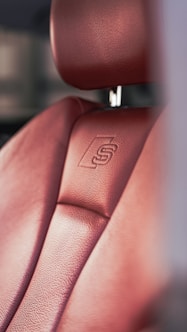 a close up of a red leather seat on a car