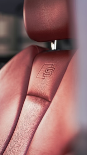 a close up of a red leather seat on a car
