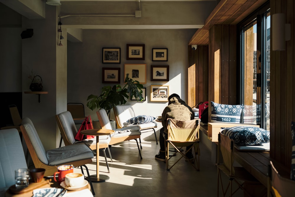 a living room filled with furniture and lots of windows