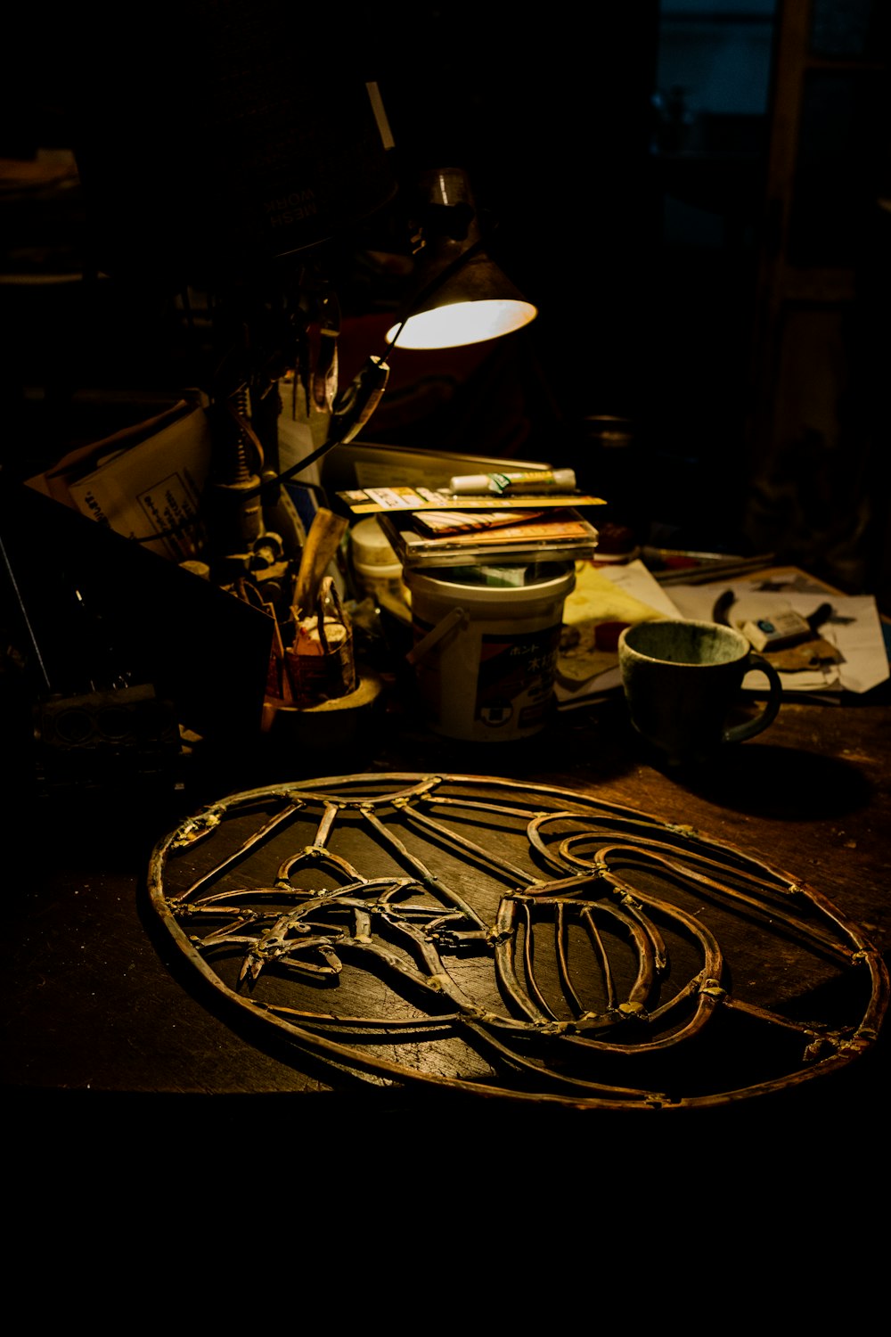 a desk with a lamp and a star wars emblem on it