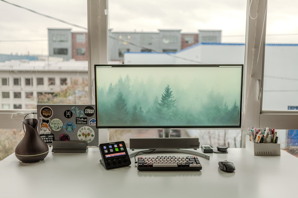 a desk with a computer monitor, keyboard and mouse