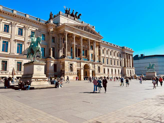 a group of people walking around a large building