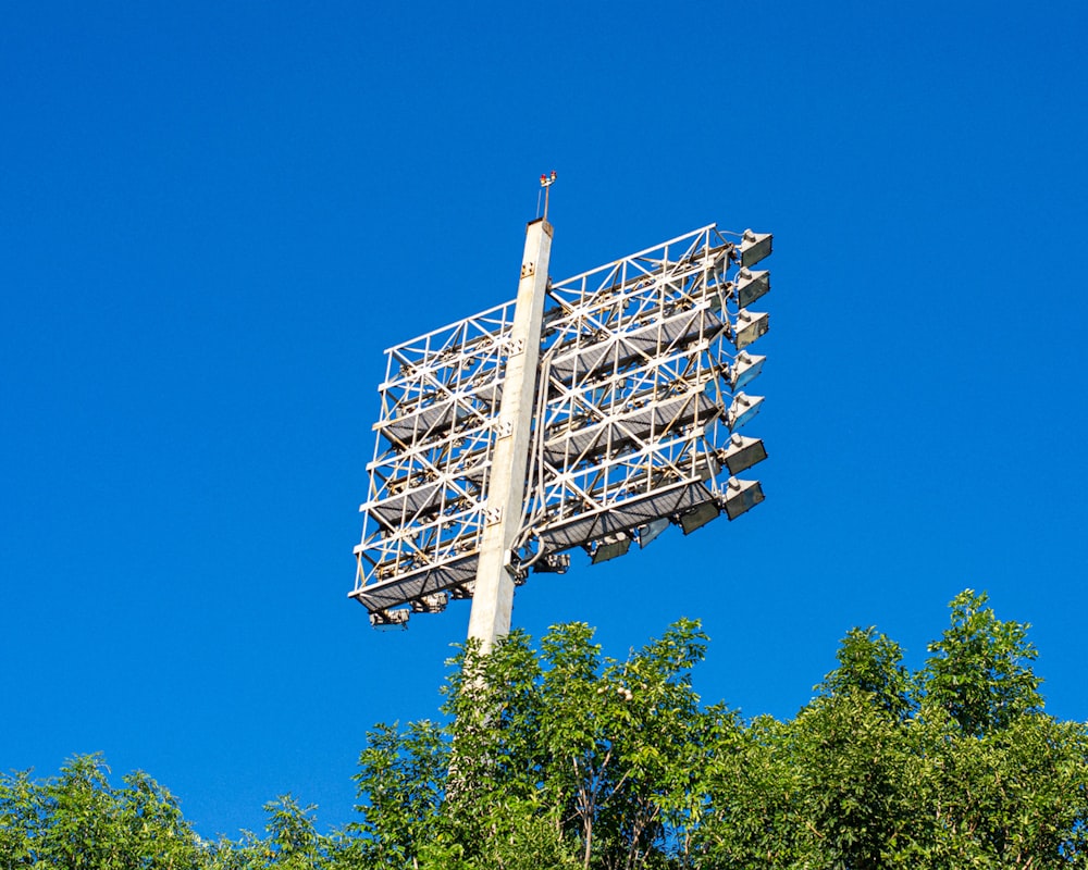 a large metal structure sitting on top of a lush green forest