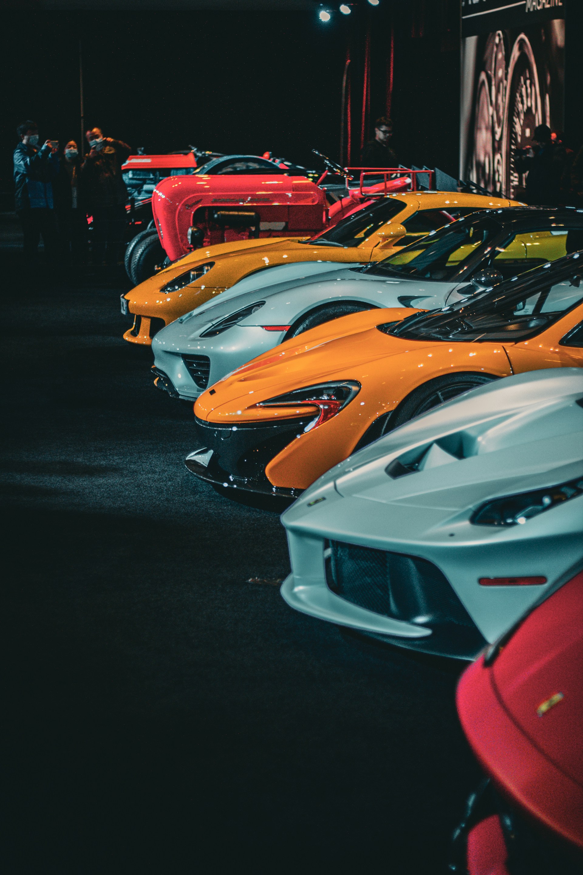 a row of different colored sports cars on display