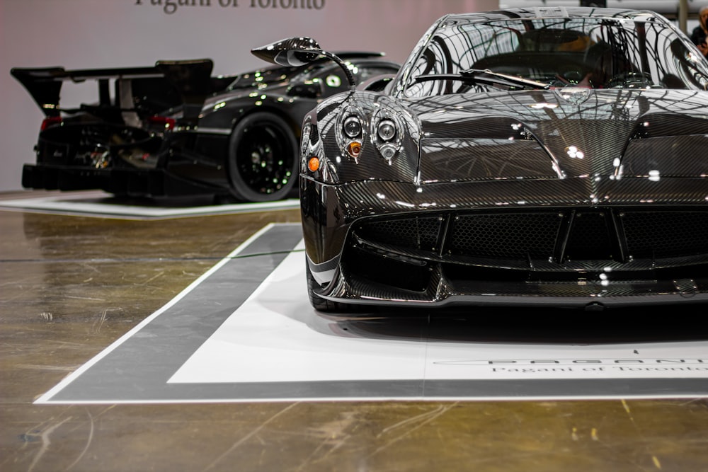 Un auto deportivo negro en exhibición en una exhibición de autos