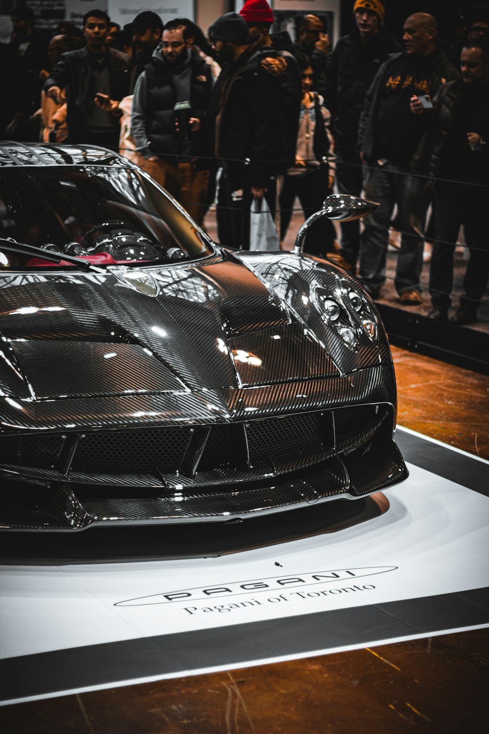 a black sports car on display at a car show