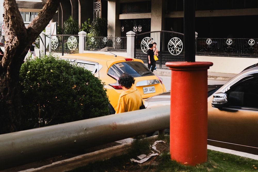 a yellow taxi is parked on the side of the road