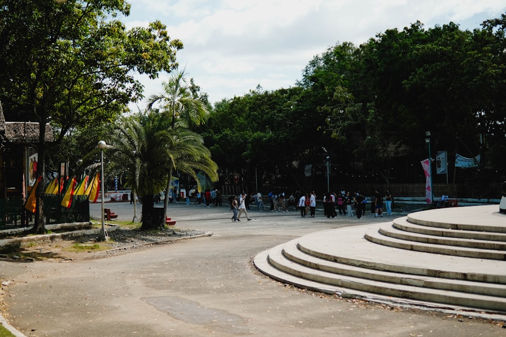 a group of people walking around a park