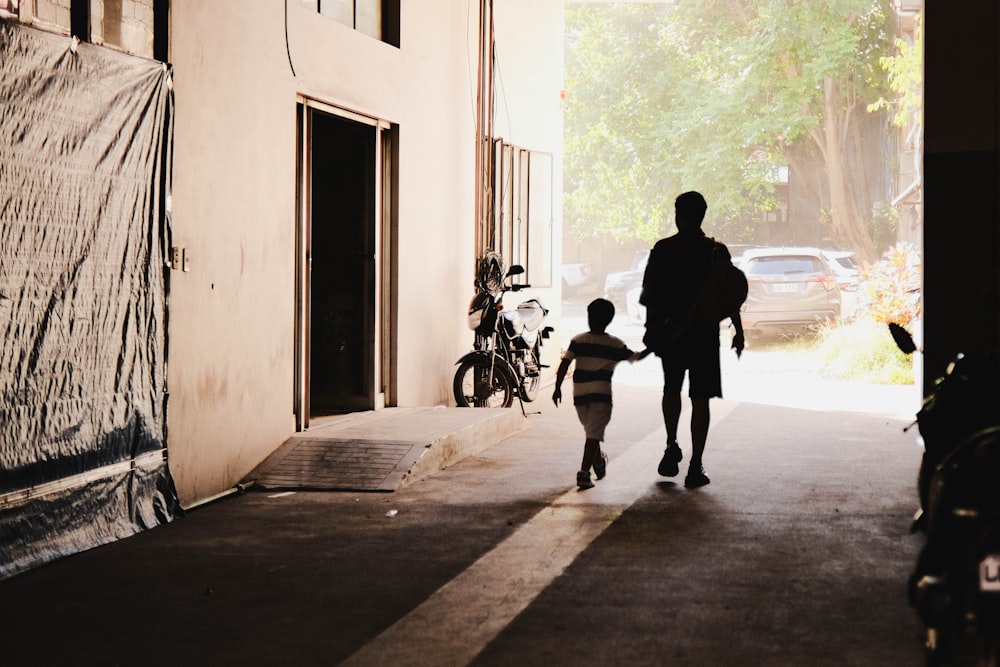 a man and a child walking down a street
