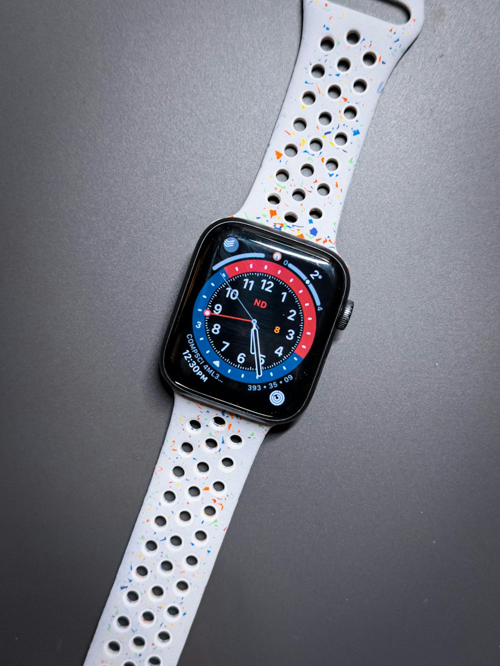 an apple watch with a blue and red face