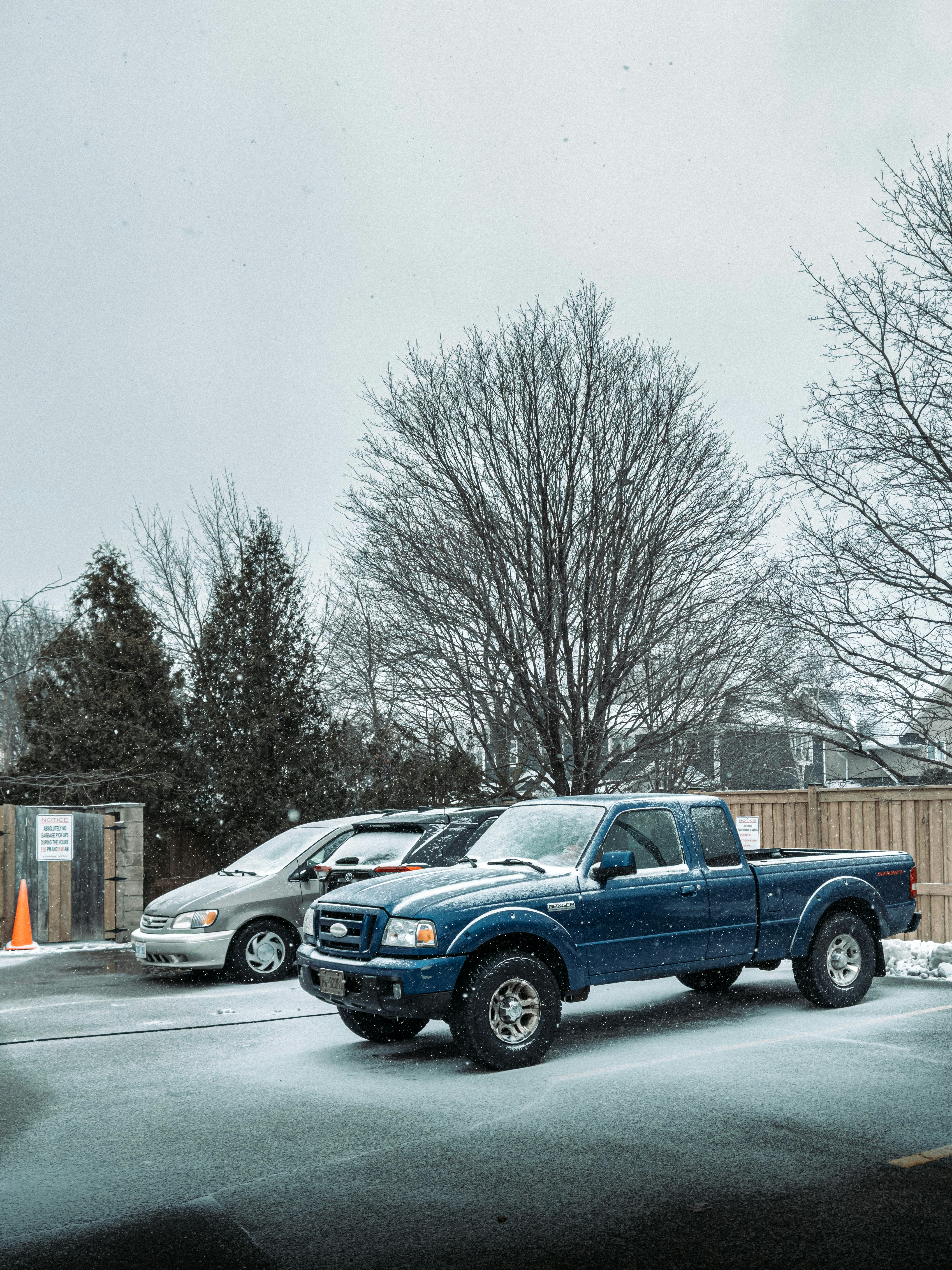 a blue pick up truck parked in a parking lot