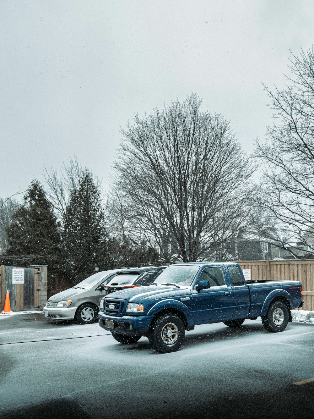 a blue pick up truck parked in a parking lot