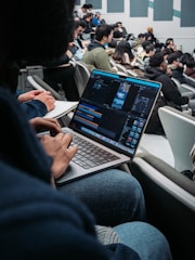 a man sitting in front of a laptop computer