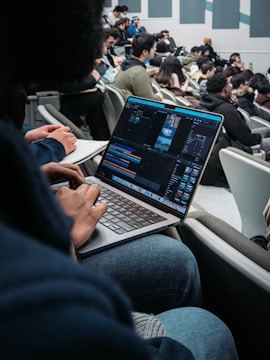 a man sitting in front of a laptop computer