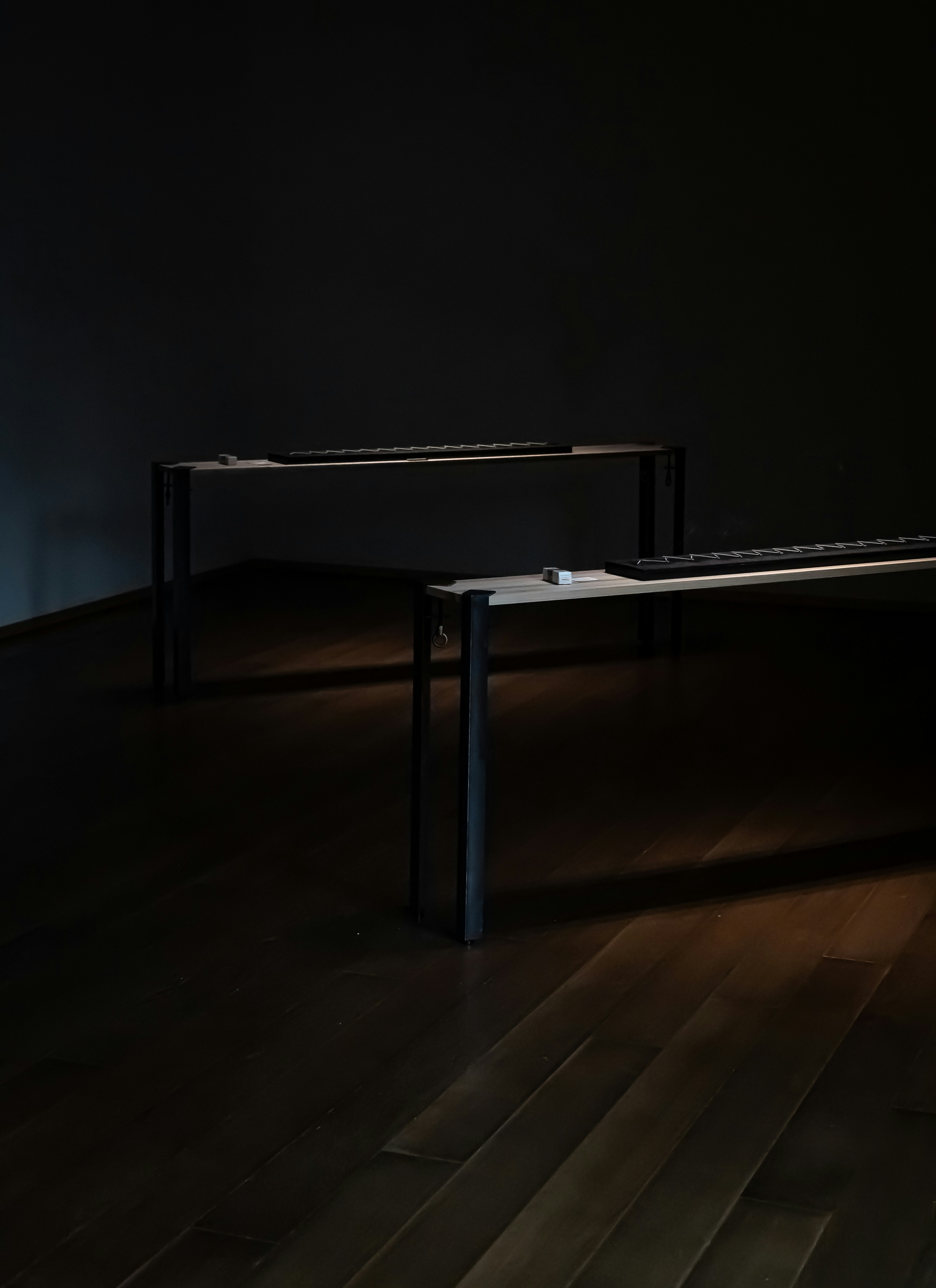 a dark room with a table and two benches