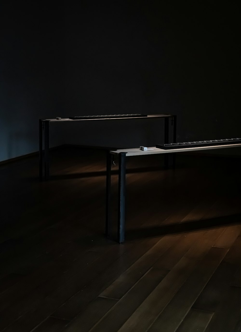 a dark room with a table and two benches