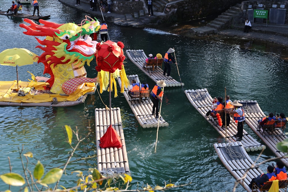 a group of people standing on rafts in a body of water