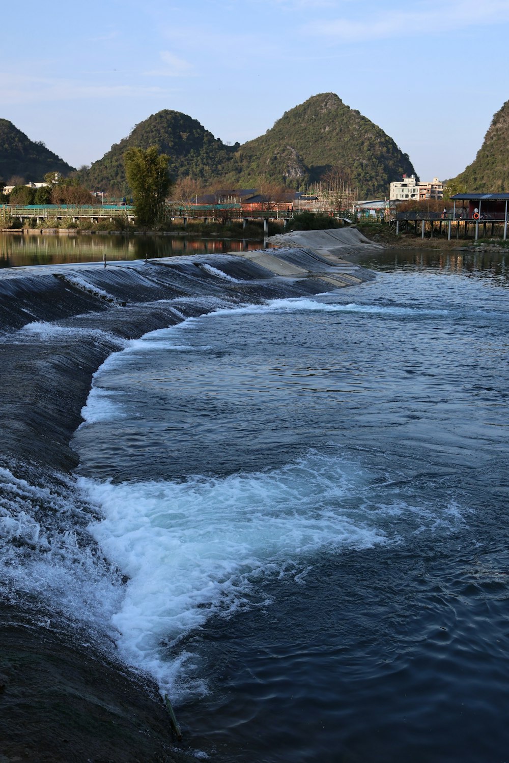 a body of water with mountains in the background