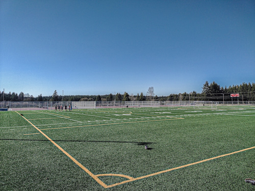 a soccer field with a few players on it